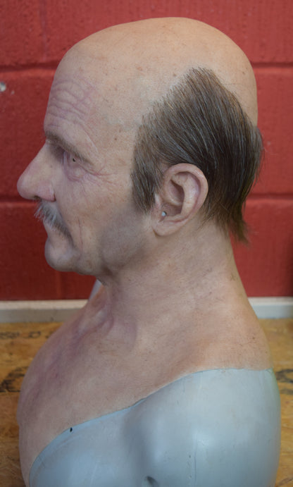 Stan old man with hand punched eyebrows, mustache and a horseshoe of hair