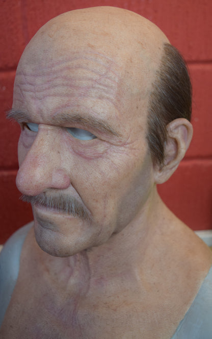 Stan old man with hand punched eyebrows, mustache and a horseshoe of hair